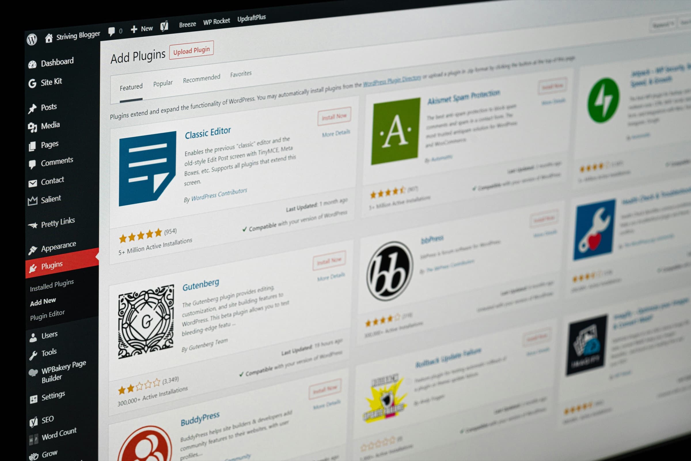 A WordPress admin screen at an angle, open on Add Plugins, with plugin cards for the Classic Editor, Gutenberg and others